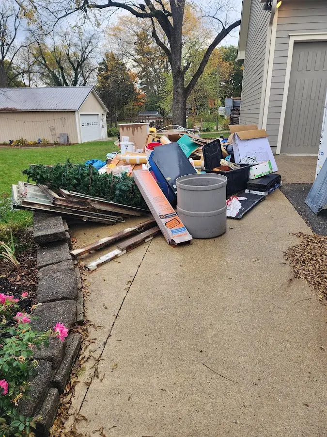Dumpster being loaded with debris for Roofing Dumpster Rental in Garden City